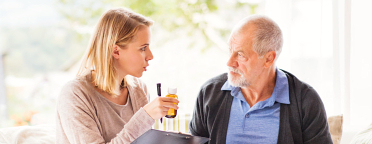 caregiver talking to the senior man